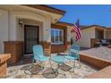 Inviting front porch with a charming seating area, brick accents, and an American flag, perfect for relaxation at 8160 E Keats Ave # 364, Mesa, AZ 85209