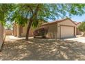 This home has a quaint entrance, a two car garage, and desert landscaping for easy maintenance at 8321 W Hughes Dr, Tolleson, AZ 85353
