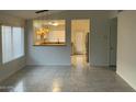 Bright, airy living room with tile floors and an open floor plan to the kitchen at 8338 W Coolidge St, Phoenix, AZ 85037