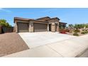 Wide driveway leading to the two-car garage of this beautiful home, enhancing curb appeal at 8350 W Carole Ln, Glendale, AZ 85305