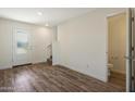 Bright entryway features wood-look flooring, a staircase, a white front door, and a convenient half-bathroom at 1074 W West Virginia Ave, Florence, AZ 85132