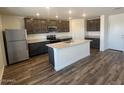 Modern kitchen features granite countertops, stainless steel appliances, and island at 1074 W West Virginia Ave, Florence, AZ 85132