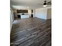 Open concept living space featuring luxury vinyl plank floors and modern kitchen at 1074 W West Virginia Ave, Florence, AZ 85132