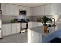 Bright kitchen featuring white cabinets, stainless steel appliances, and a spacious countertop at 11250 N 33Rd Ave, Phoenix, AZ 85029