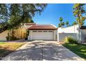 Home featuring a two-car garage and a well-maintained driveway at 1134 E Driftwood Dr, Tempe, AZ 85283
