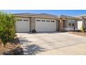 Inviting home featuring a three-car garage, desert landscaping, and a neutral color palette at 12176 E Chevelon Trl, Gold Canyon, AZ 85118