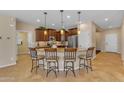 Spacious kitchen island with granite countertop, pendant lighting, and seating for four at 17179 S 174Th S Dr, Goodyear, AZ 85338
