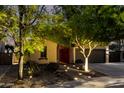 Beautiful single-story home with desert landscaping, and warm lighting, creating an inviting ambiance at 17363 W Lisbon Ln, Surprise, AZ 85388