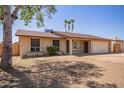 Charming single-story home features a two-car garage and low-maintenance front yard at 18402 N 17Th Ave, Phoenix, AZ 85023