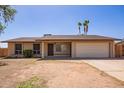 Charming single-story home features a two-car garage and low-maintenance front yard at 18402 N 17Th Ave, Phoenix, AZ 85023