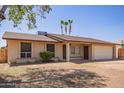 Charming single-story home features a two-car garage and low-maintenance front yard at 18402 N 17Th Ave, Phoenix, AZ 85023