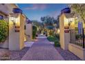 Elegant entryway with brick pathway and landscaped garden welcomes visitors at 18927 N 101St St, Scottsdale, AZ 85255