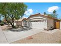Well-maintained home featuring a two-car garage, desert landscaping, and a terra cotta tile roof at 19127 N 79Th Dr, Glendale, AZ 85308