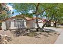 Single-story home with stucco exterior, terra cotta roof tiles, and a front yard featuring low-maintenance desert landscaping at 19127 N 79Th Dr, Glendale, AZ 85308