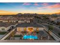 A captivating aerial view highlighting the backyard pool, fire pit and neighborhood at 20426 E Arroyo Verde Dr, Queen Creek, AZ 85142