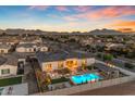Aerial view showcasing a backyard oasis with a sparkling pool, covered patio, and mountain views at 20426 E Arroyo Verde Dr, Queen Creek, AZ 85142