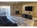 Comfortable living room with a brick fireplace, sliding glass doors, and patio access at 2123 E Kirkland Ln # 3, Tempe, AZ 85281