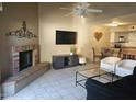 Open concept living room with fireplace and view into the dining area and kitchen at 2123 E Kirkland Ln # 3, Tempe, AZ 85281