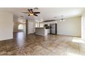 Open-concept living space featuring a kitchen with stainless steel appliances and breakfast bar at 2129 E Yuma Ave, Apache Junction, AZ 85119