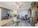 Comfortable living room with a ceiling fan, recliner chairs, and hardwood floors, providing a cozy ambiance at 2202 W Enid Ave, Mesa, AZ 85202