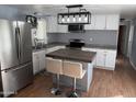 Modern kitchen features stainless steel appliances, white cabinets, and eat-in island at 235 W Southern Ave # 150, Mesa, AZ 85210