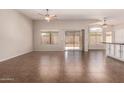Spacious living room showcasing tile floors, ceiling fans, and sliding door access to the patio at 385 E Ironwood Dr, Chandler, AZ 85225