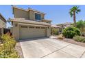 Two-story home with a two car garage, tile roof, and desert landscaping at 3929 W Goldmine Mountain Dr, San Tan Valley, AZ 85144