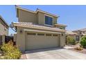Two-story home with a two car garage, tile roof, and desert landscaping at 3929 W Goldmine Mountain Dr, San Tan Valley, AZ 85144