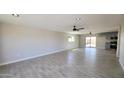 Bright, open living area with wood-look tile flooring, recessed lighting, and ceiling fans at 4219 W Citrus Way, Phoenix, AZ 85019