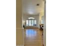 Bright, airy living room with wood floors, archways and large windows that flood the space with natural light at 4322 E Cottonwood Ln, Phoenix, AZ 85048