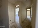 A bright hallway with multiple doorways showcases the layout of the home under construction at 47214 W Cansados Rd, Maricopa, AZ 85139