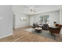 Bright living room with wood flooring, gray sofa, decorative pillows, and an accent chair at 5022 W Pierson St, Phoenix, AZ 85031