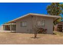Single story home with neutral exterior and backyard with room for seating at 5738 W Heatherbrae Dr, Phoenix, AZ 85031