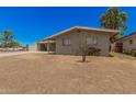 Single story home with neutral exterior and backyard with room for seating at 5738 W Heatherbrae Dr, Phoenix, AZ 85031