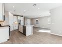 Stylish kitchen featuring white cabinetry, stainless steel appliances, and center island with a sink at 5844 E Covey Ln, Phoenix, AZ 85054