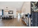 Elegant foyer featuring wood-look flooring, a dining area, and a glimpse of the kitchen at 6164 E Greenway Ln, Scottsdale, AZ 85254