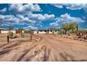 View of home with detached garage and desert landscaping, new roof, and new exterior paint at 639 N 102Nd Pl, Mesa, AZ 85207