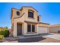 Charming two-story home with a two-car garage and low-maintenance desert landscaping in front at 6505 S 15Th Dr, Phoenix, AZ 85041