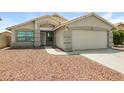 Inviting home with desert landscaping, showcasing the well-manicured front yard and inviting entrance at 6875 W Townley Ave, Peoria, AZ 85345