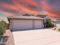 Attractive single-level home boasting a three-car garage and low-maintenance landscaping at 11424 S Obispo Dr, Goodyear, AZ 85338