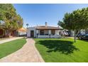 Inviting single-story home with a red-tiled roof, and a neatly landscaped yard at 1309 W Lynwood St, Phoenix, AZ 85007