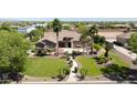 Beautiful home with a meticulously landscaped yard, mature palms, and a stone entrance, offering great curb appeal at 16386 W Papago St, Goodyear, AZ 85338