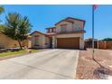 Lovely two-story home with an expansive driveway, a tidy lawn, and a prominent American flag at 19324 N Del Mar Ave, Maricopa, AZ 85138