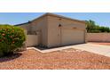 Attached two-car garage with neutral exterior and well-maintained landscaping at 19833 N 47Th Ln, Glendale, AZ 85308