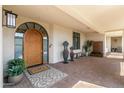 Inviting front entrance with arched doorway, covered walkway, and stylish decor creating a welcoming curb appeal at 2 Biltmore Est # 313, Phoenix, AZ 85016