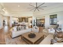 Open-concept living room featuring high ceilings, modern fan, and seamless flow to kitchen and dining areas at 2 Biltmore Est # 313, Phoenix, AZ 85016