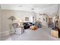 Relaxing living area with a vaulted ceiling, neutral carpet, and comfortable seating at 20739 N 106Th Ln, Peoria, AZ 85382