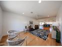 Bright and airy living room with hardwood floors and an open floor plan flowing into the kitchen at 228 E Del Rio Dr, Tempe, AZ 85282