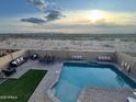 Inviting backyard with a private pool, patio seating, and desert views at 22812 N 123Rd Dr, Sun City West, AZ 85375