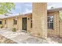 Attractive brick home featuring an entryway with secure black metal door and tidy landscaping at 2515 S Maple Ave # 103, Tempe, AZ 85282